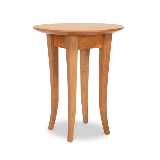 Lyndon Furniture Classic Shaker Round End Table with curved flare legs and a natural wood finish, highlighting the craftsmanship and elegant design.
