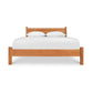 Classic Wood Bed by Lyndon Furniture showcasing a solid wood frame and high headboard with a white mattress and pillows.