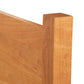 Classic Wood Bed corner by Lyndon Furniture highlighting smooth wood grain, clean lines, and a light brown finish.