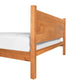 Classic Wood Bed made from sustainably harvested wood with a natural finish, includes white mattress.
