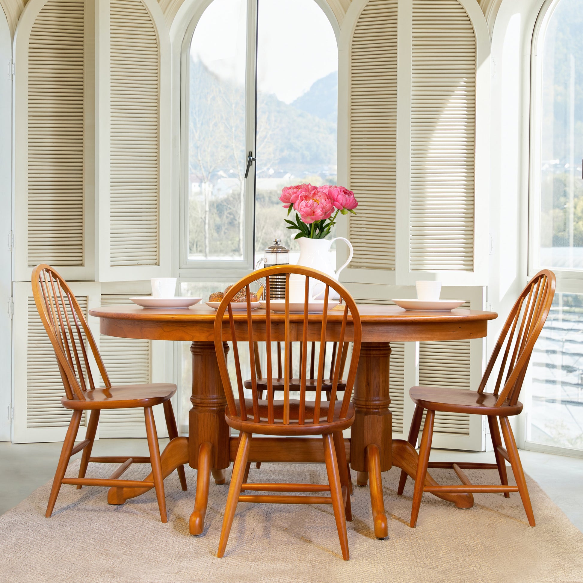 Lyndon Furniture Contemporary Windsor Side Chair – Floor Model at a solid wood dining table, showcasing fine American craftsmanship.