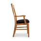 Vermont Woods Studios Country Shaker Arm Chair with black upholstered seat and ergonomic solid wood frame, side view.