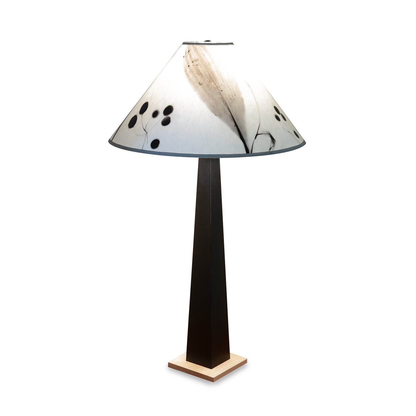 Dance of Life Table Lamp by Rock River Studio with a tall black base, cherry wood platform, and wide white shade.
