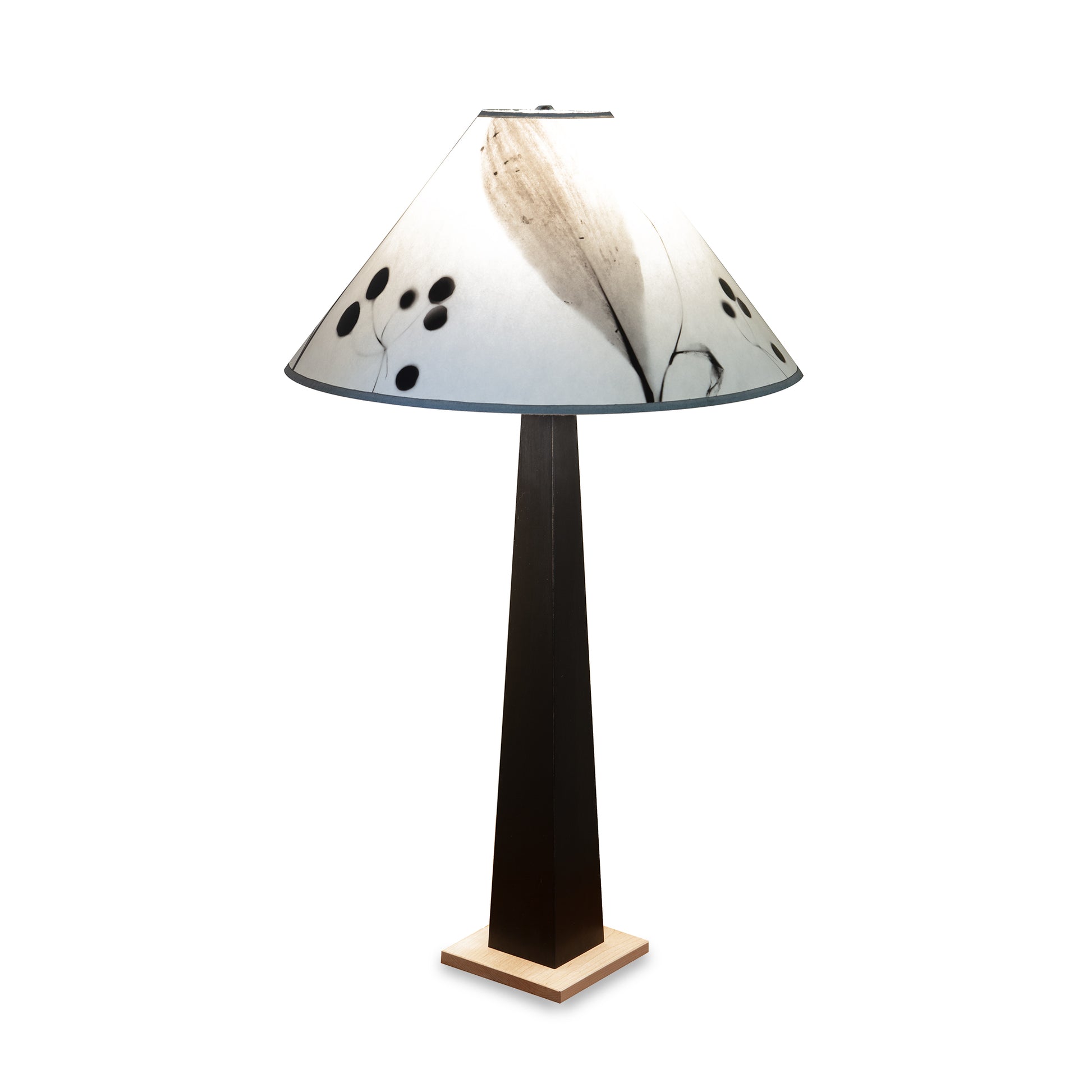 Dance of Life Table Lamp by Rock River Studio with a tall black base, cherry wood platform, and wide white shade.