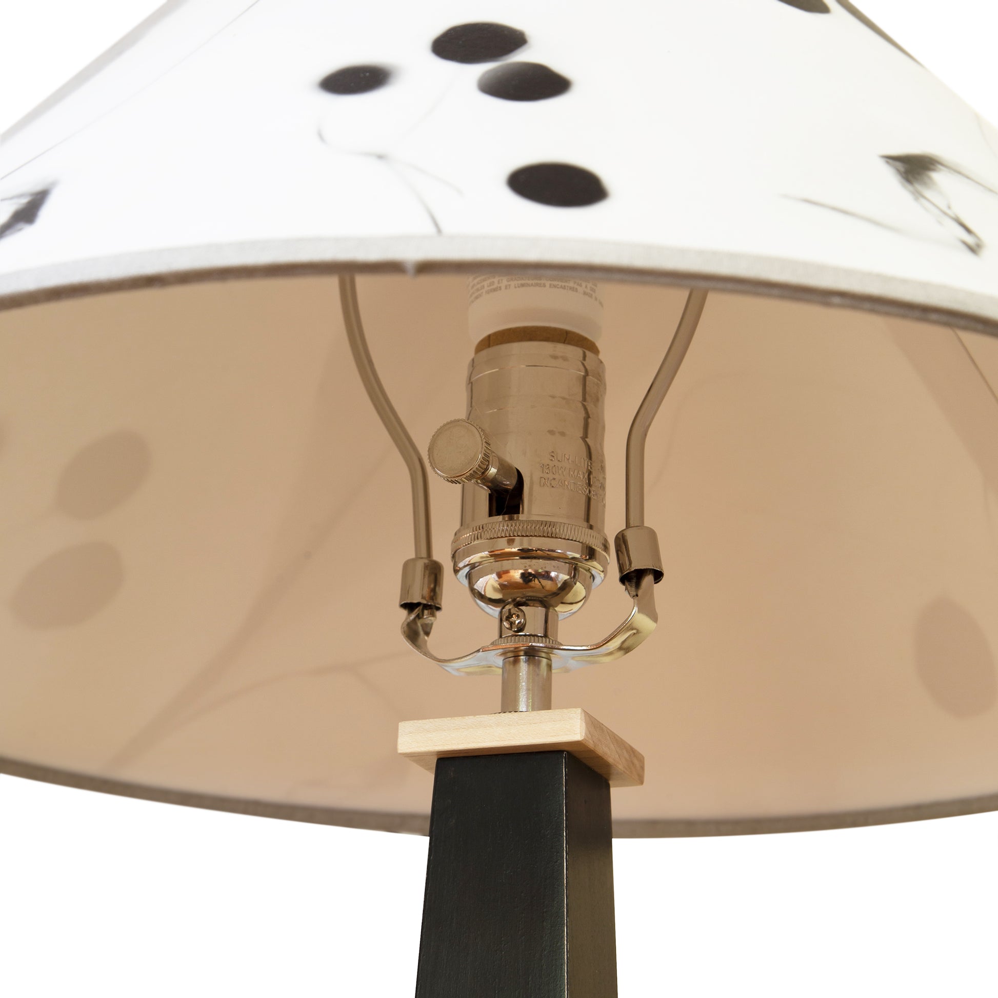 Dance of Life Table Lamp by Rock River Studio with a cherry wood base and a distinctive white shade accented with black dots.