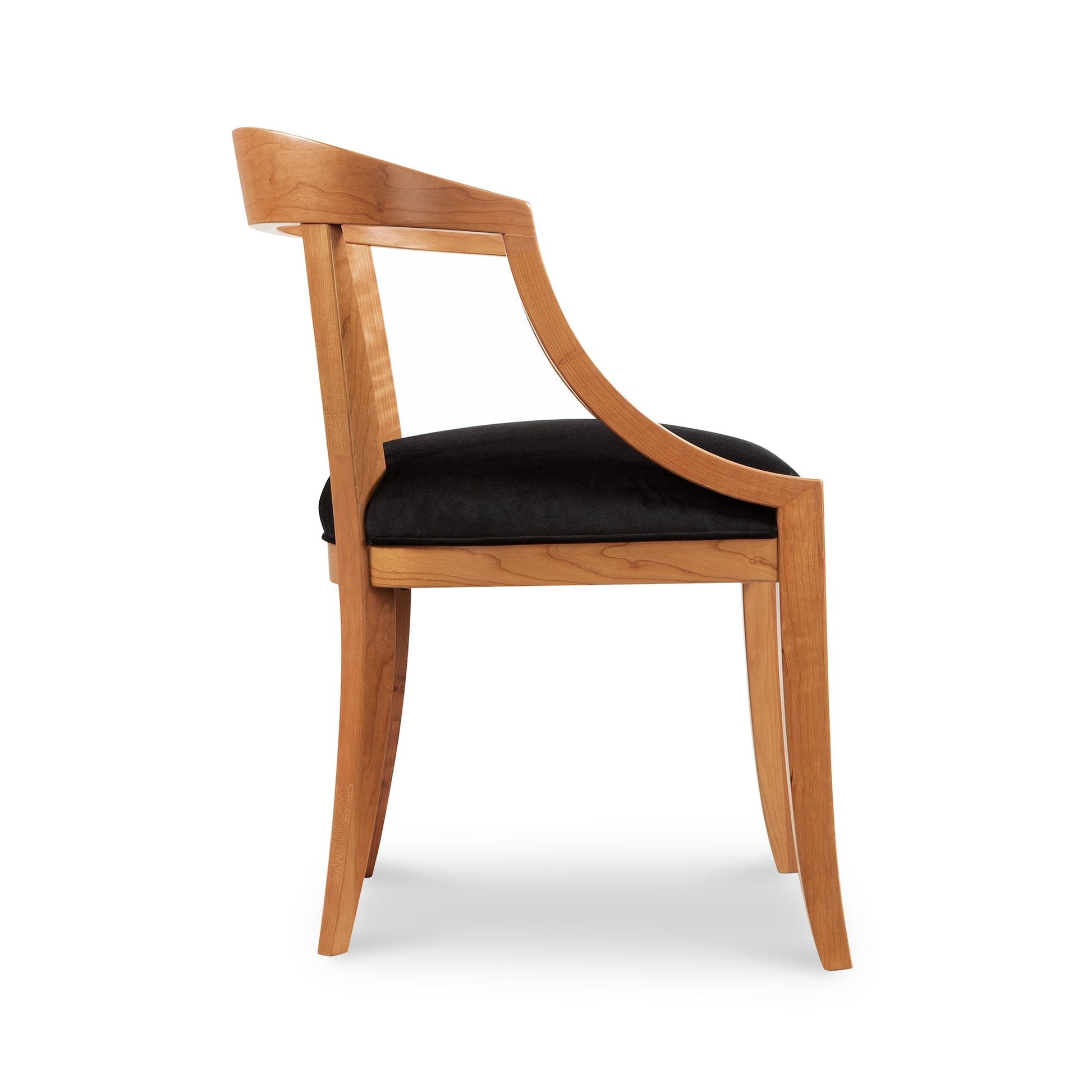 Dorset Chair by Vermont Woods Studios featuring black upholstery, curved arms, and elegant legs, emphasizing its comfortable and stylish design.