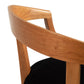 Dorset Chair by Vermont Woods Studios with a curved backrest and black seat, showcasing intricate wood grain and craftsmanship.