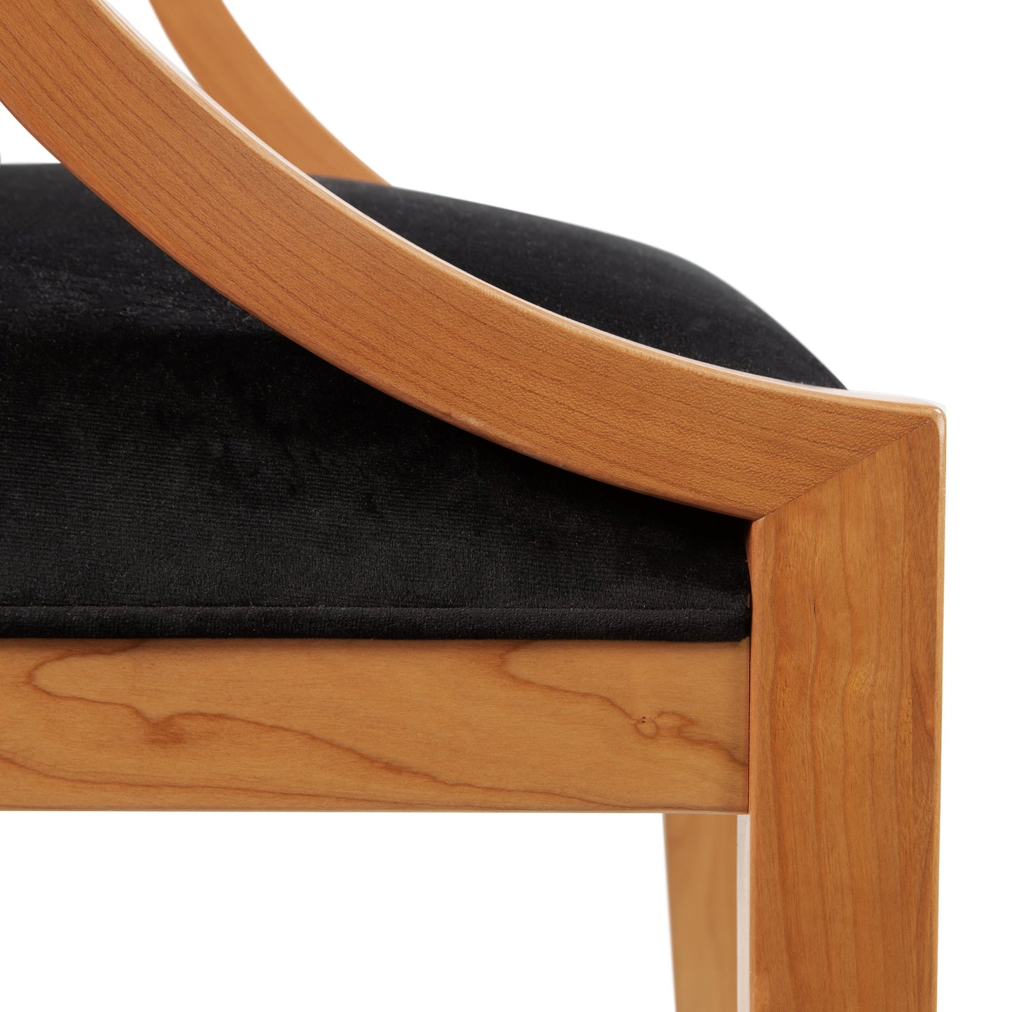 Dorset Chair floor model by Vermont Woods Studios featuring black upholstery, detailed wood grain, and curved armrest.
