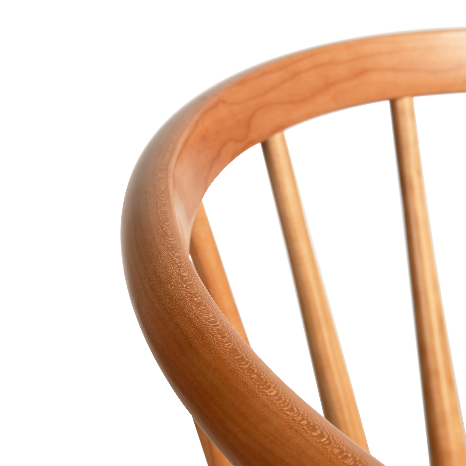 Dover Curveback Windsor Chair in cherry by Vermont Woods Studios, showcasing its distinct curved top rail and classic vertical spindles.