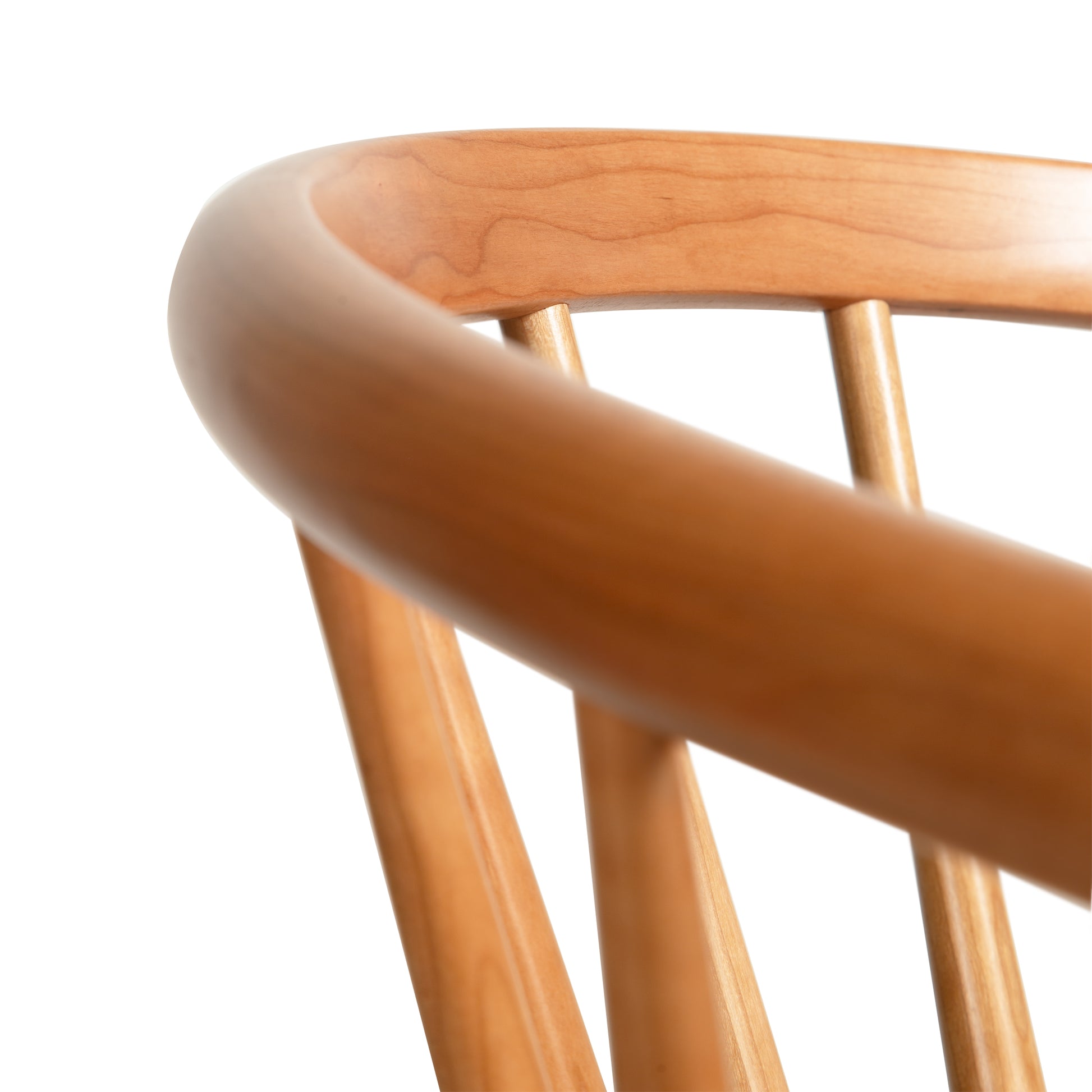 Close-up of Dover Curveback Windsor Chair in Cherry by Vermont Woods Studios, highlighting its elegant curved backrest and finely crafted spindles.