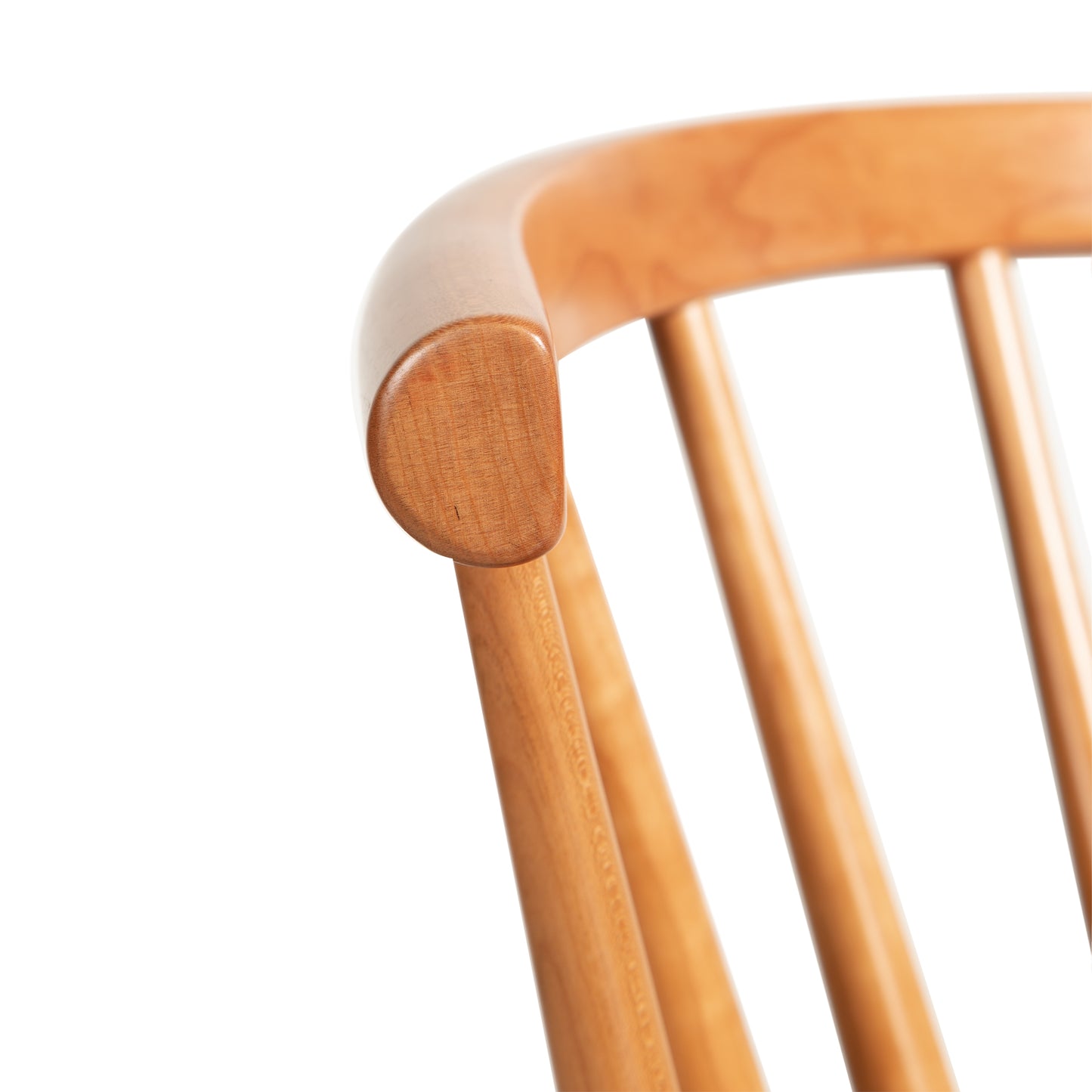Dover Curveback Windsor Chair in Cherry by Vermont Woods Studios, highlighting the elegant curved backrest and detailed spindle rods.