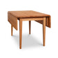 Lyndon Furniture Drop Leaf Table in natural cherry wood with one leaf extended, highlighting its craftsmanship and convertible design.
