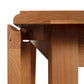 Lyndon Furniture Drop Leaf Table in cherry wood, highlighting the detailed leg design with metal hinge and folding mechanism.