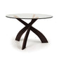 Copeland Entwine round dining table with clear glass top and three sculpted cherry wood legs.