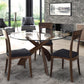 Copeland Entwine round glass top dining table with three wooden chairs featuring dark cushions, showcasing elegant craftsmanship and contemporary design.
