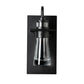 Close-up of the Erlenmeyer Medium Outdoor Sconce by Hubbardton Forge, highlighting its sturdy black frame and clear glass industrial design.