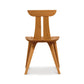 Estelle Chair by Copeland Furniture showcasing solid American hardwood with a natural finish, elegant curved backrest, and sleek angled legs.