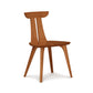 Minimalist Estelle Chair by Copeland Furniture features a curved backrest and angled legs, expertly crafted from American hardwoods.