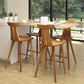 Set of four Estelle Counter Stools by Copeland Furniture, handcrafted from solid hardwood, displayed around a kitchen island.