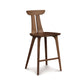 Estelle Counter Stool by Copeland Furniture with a sculpted curved backrest, angled legs, and footrest in natural wood finish.