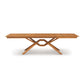 Exeter Extension Dining Table featuring a wooden rectangular top with a butterfly leaf and geometric crossed-leg design by Copeland Furniture.
