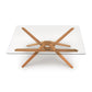 Exeter Rectangular Glass Top Table by Copeland Furniture with modern angled hardwood legs, highlighting craftsmanship and sleek design.