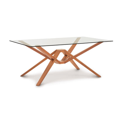 Exeter Rectangular Glass Top Table by Copeland Furniture with intersecting hardwood legs and a clear glass surface.