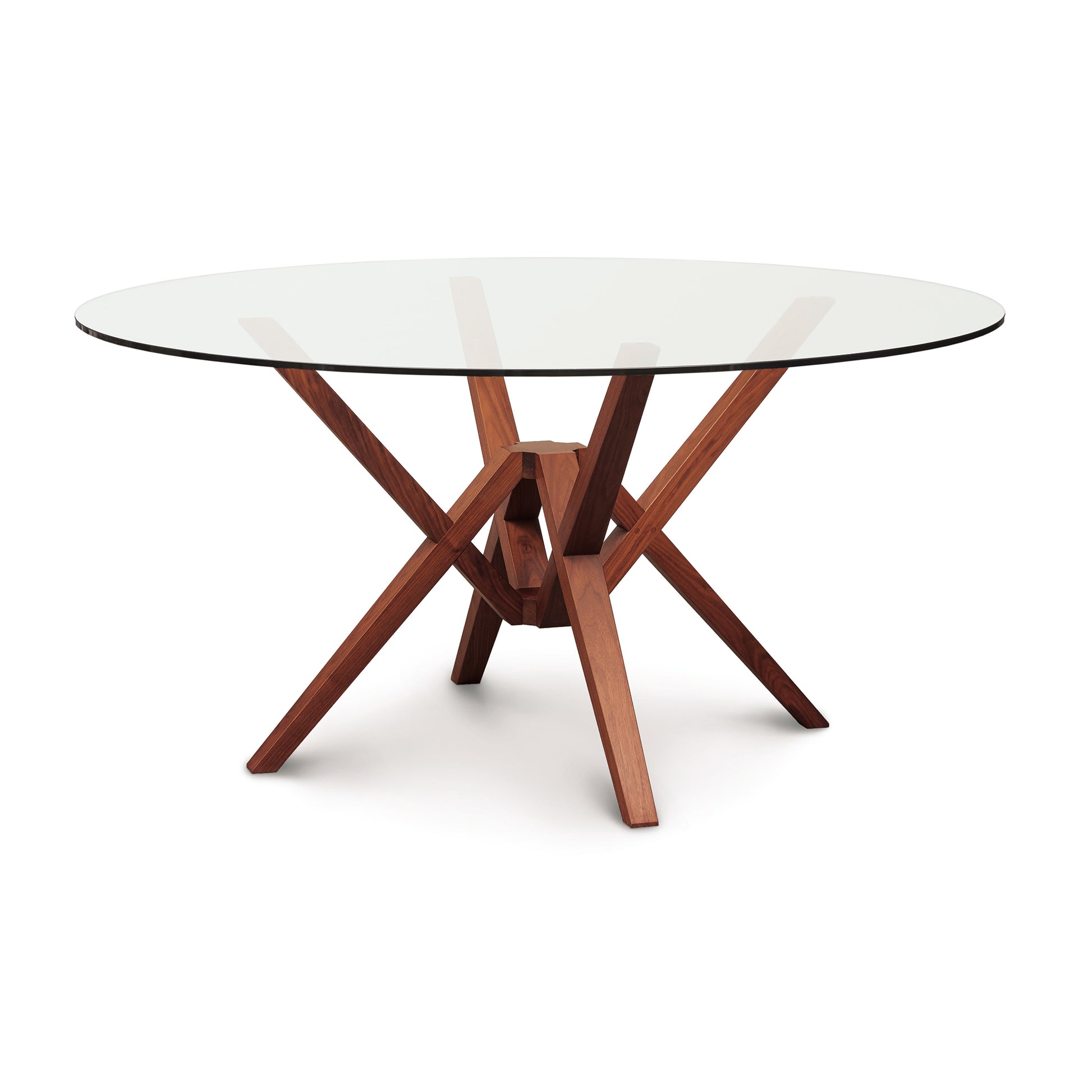 Exeter Round Glass Top Table by Copeland Furniture with intersecting angled hardwood legs and a solid, sustainably sourced wood base.