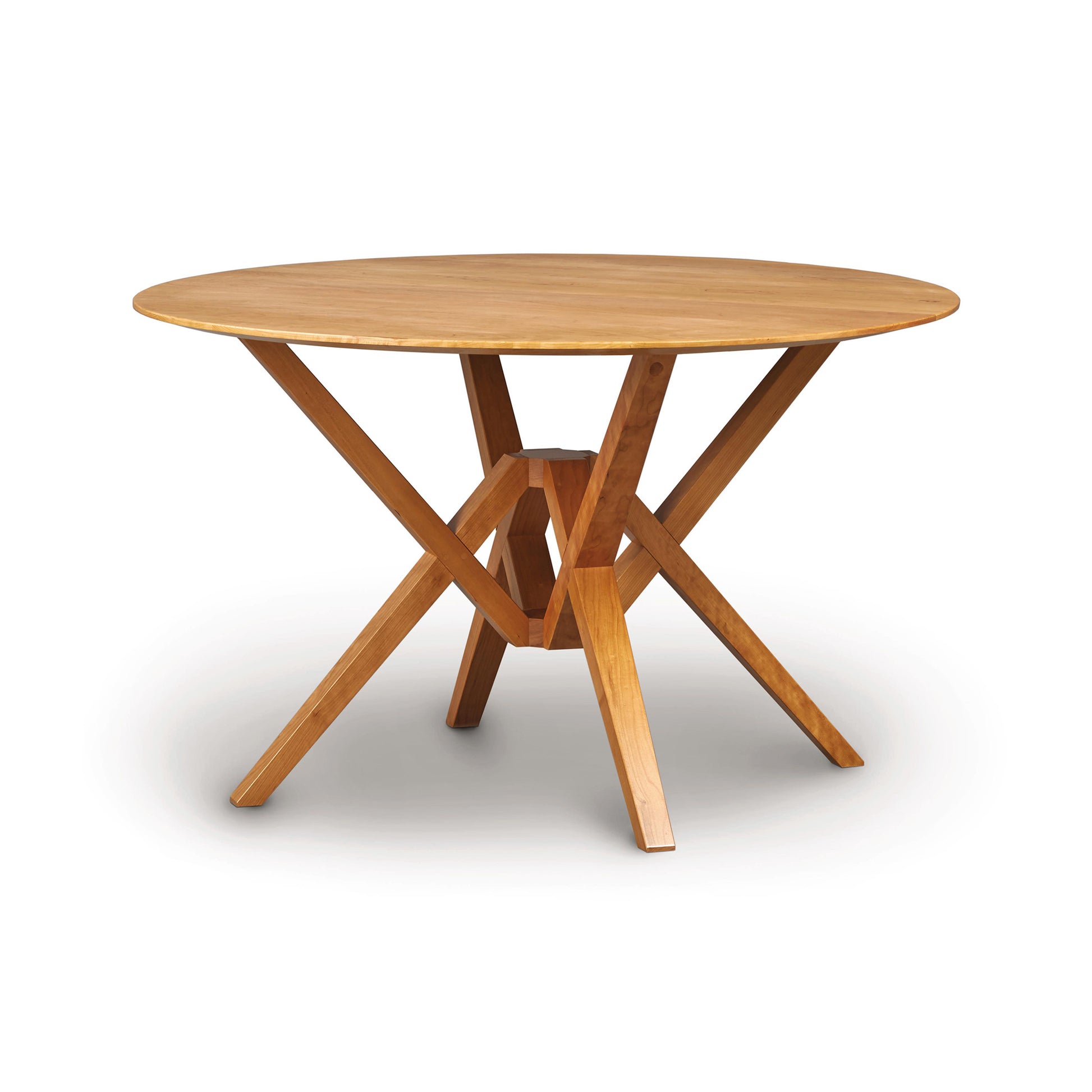 Exeter Round Solid Top Dining Table by Copeland Furniture, showcasing angled legs and geometric design in sustainable hardwood.