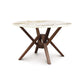 Exeter Round Table by Copeland Furniture with white marble-like sintered stone top and striking geometric hardwood legs.