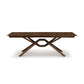 Exeter Extension Dining Table with rectangular top and crossed geometric base, crafted from North American hardwood by Copeland Furniture.