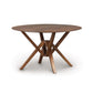 Exeter Round Solid Top Dining Table by Copeland Furniture, showcasing a natural hardwood top and unique geometric legs, handcrafted in Vermont.