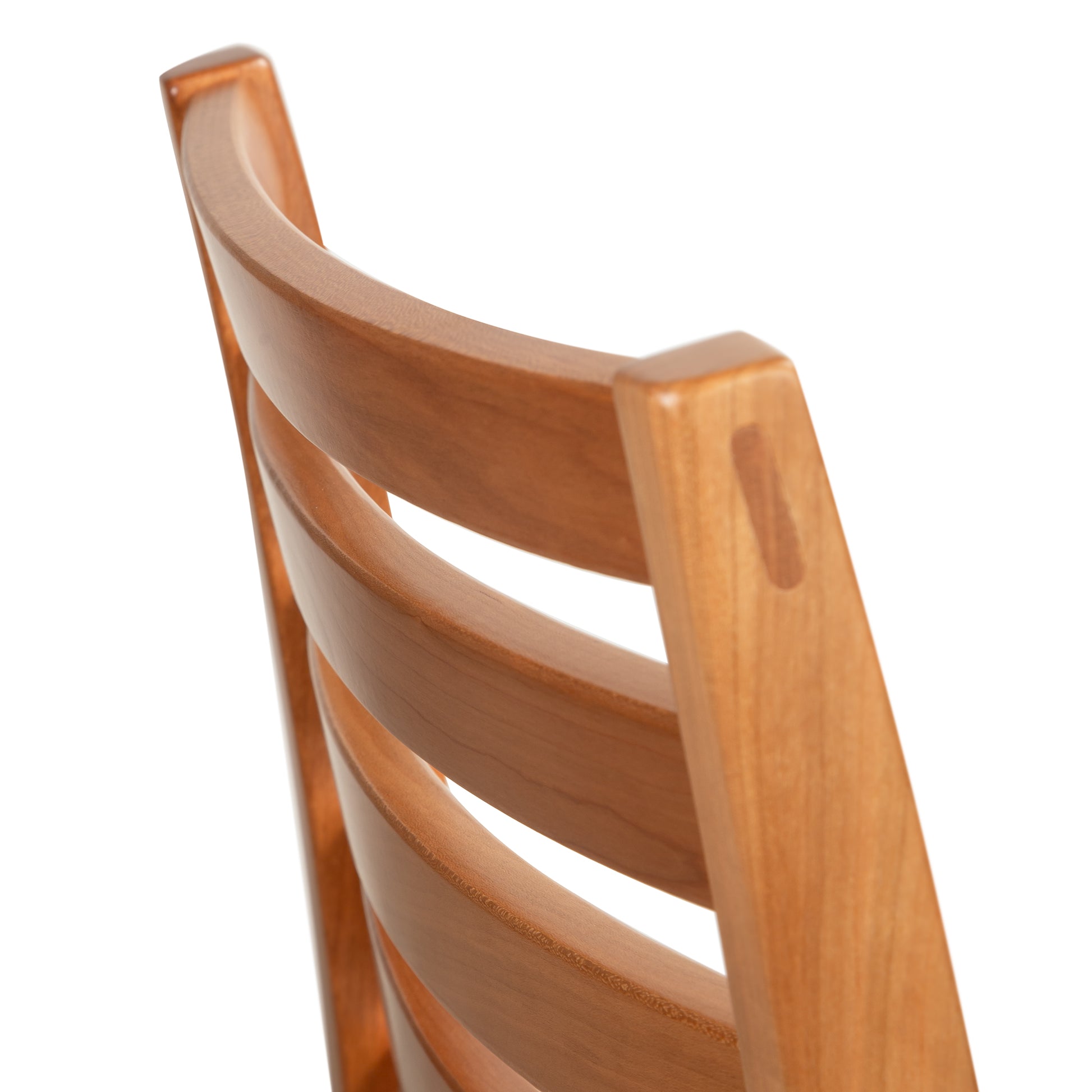 Grafton Chair in cherry by Vermont Woods Studios, featuring a curved slatted backrest; detailed close-up of premium American craftsmanship.