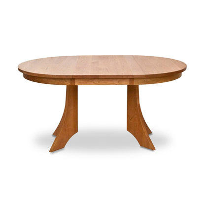 Hampton Split Pedestal Extension Table by Lyndon Furniture showcasing an oval wood top with two graceful curved pedestal bases.