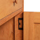 Detail view of the Heartwood Shaker 1-Drawer Nightstand with Door, highlighting its quality metal hinge craftsmanship by Vermont Furniture Designs.