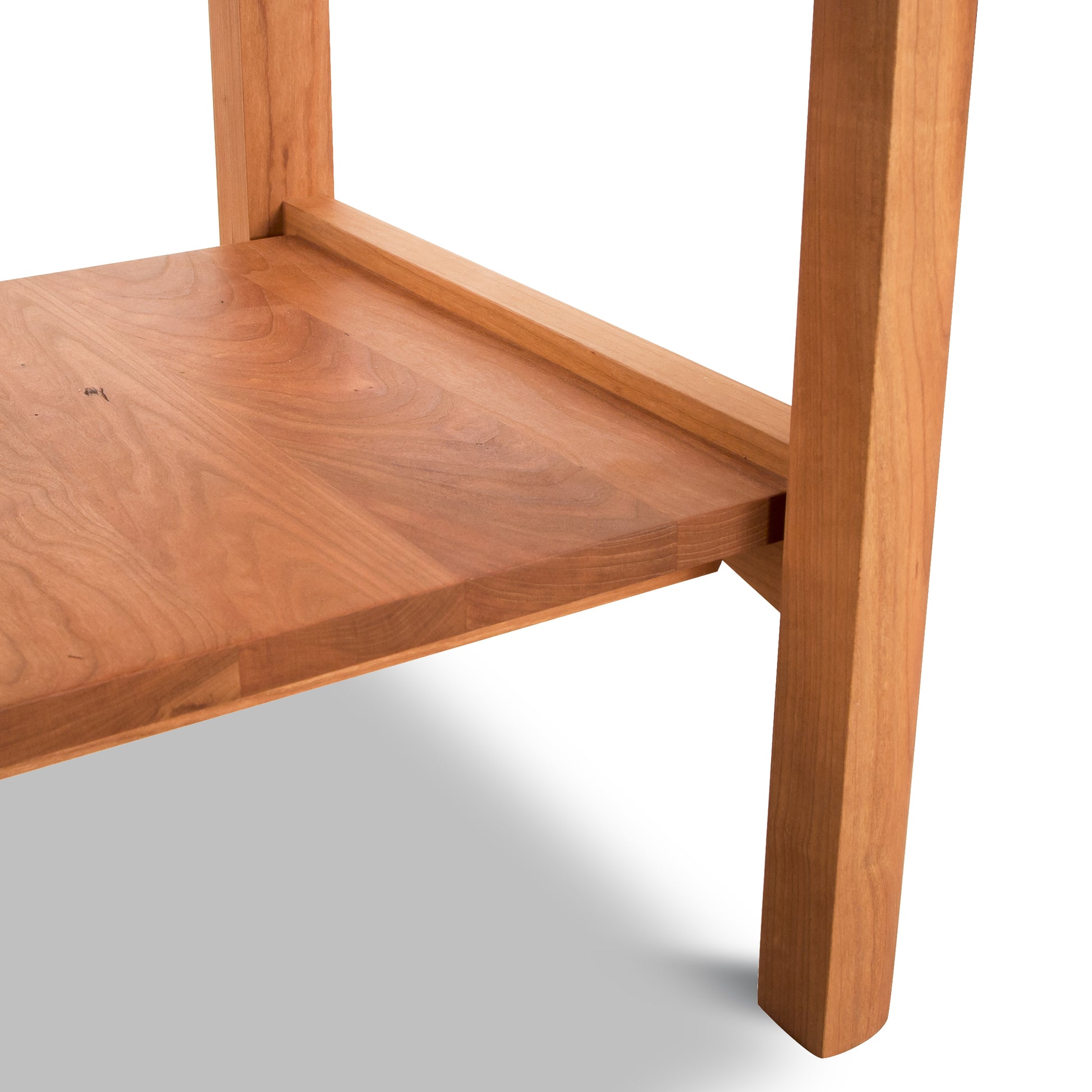 Vermont Furniture Designs Heartwood Shaker Open Shelf Nightstand in solid wood, highlighting expert joinery and elegant leg grain.