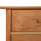 Detail of the Heartwood Shaker 4-Drawer Dresser by Vermont Furniture Designs, highlighting the wood grain and quality craftsmanship on the top left drawer and knob.