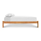 Vermont Furniture Designs Heartwood Shaker Studio-Style Platform Bed featuring a minimalist, elegant design with a white sheet and pillow.