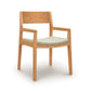 Iso Chair by Copeland Furniture with angled light wood frame and light gray cushion, expertly crafted from sustainable hardwoods.