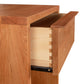 Kipling 1-Drawer Enclosed Shelf Nightstand from Vermont Furniture Designs showcasing modern design with a partially open drawer revealing natural wood charm.