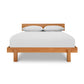 Solid wood Kipling Bed by Vermont Furniture Designs with white sheets and pillows on a sturdy mattress.