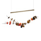 Hubbardton Forge Lily LED Pendant with a gold linear bar, sculpted branch accents, and colorful discs highlighting its modern, handcrafted design.