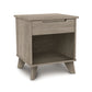 Linn Nightstand by Copeland Furniture in solid wood with one drawer, open shelf, angled legs, and light brown finish.