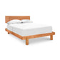 Loft Bed from Vermont Furniture Designs with a cherry wood frame and matching headboard, complemented by a white mattress and pillows.