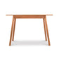 Manchester Cherry Compact Desk by Vermont Woods Studios, crafted from solid cherry with sleek angled legs, showcases American-made quality craftsmanship.