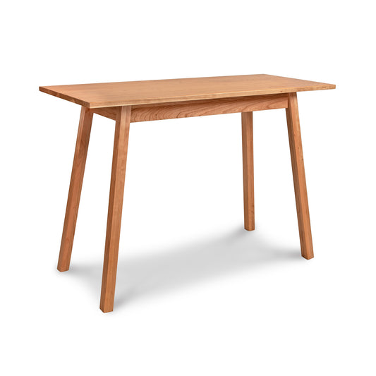 Manchester Cherry Compact Desk by Vermont Woods Studios, crafted in solid cherry wood with angled legs, showcasing modern American craftsmanship.