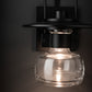 Mason Outdoor Sconce by Hubbardton Forge showcases American craftsmanship with a hand-blown glass shade and black metal design.
