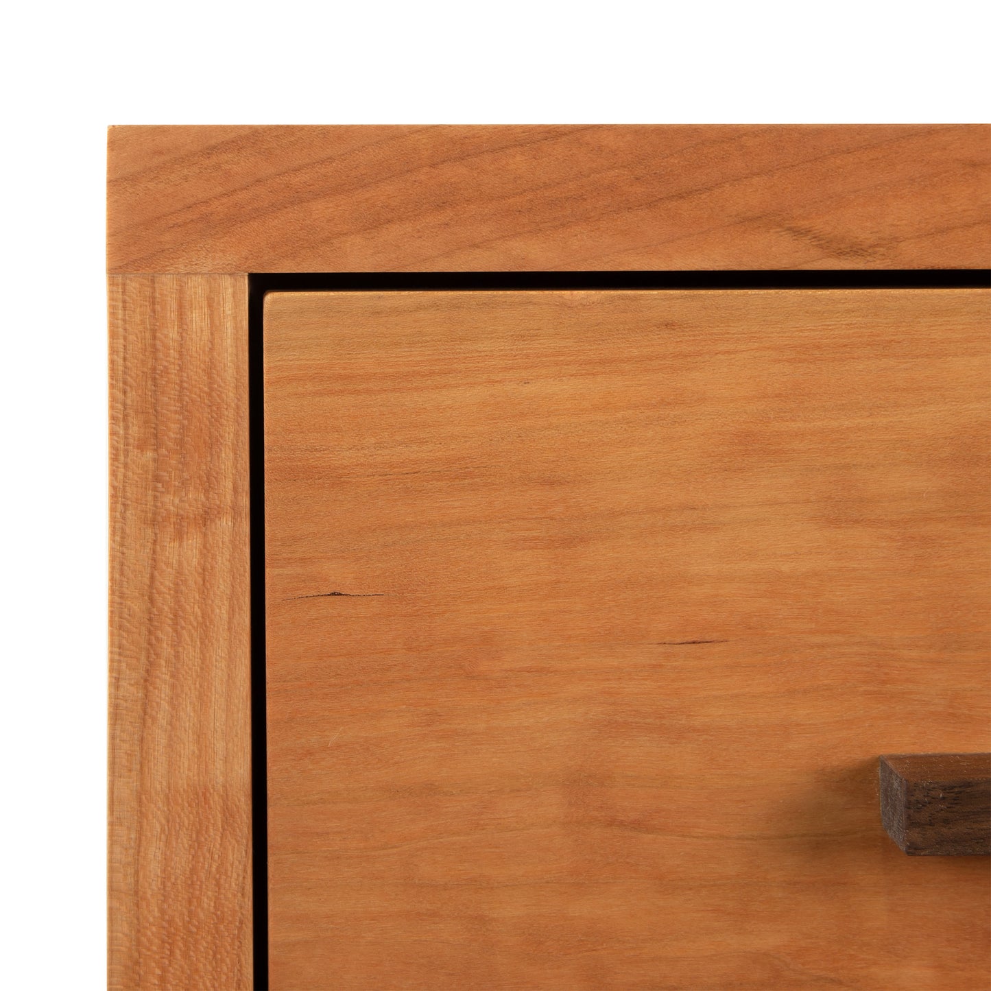Close-up of the Modern American 1-Drawer Enclosed Shelf Nightstand by Vermont Furniture Designs, highlighting the drawer with a small handle.