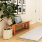 Modern American Bench by Vermont Furniture Designs featuring plush cushions, showcasing its sleek design and craftsmanship in a well-lit interior.