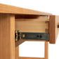 Modern Craftsman 2-Drawer Console Table by Vermont Furniture Designs, highlighted with a detailed view of its high-quality wooden drawer featuring a metal slider labeled "PRO 2.0 SERIES".